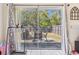 View of outdoor patio through the sliding glass doors, featuring metal seating and a privacy fence at 1309 Malone Ave, Spring Hill, FL 34606