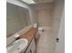 Bright bathroom featuring a vanity with a marble countertop and tiled floors at 1309 Malone Ave, Spring Hill, FL 34606