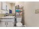 Modest bathroom featuring a toilet, single sink vanity and shelves at 1309 Malone Ave, Spring Hill, FL 34606