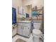 Modest bathroom featuring a toilet, single sink vanity and shelves at 1309 Malone Ave, Spring Hill, FL 34606