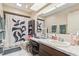 Bathroom featuring a skylight, large mirror, vanity, and shower with decorative curtain at 1309 Malone Ave, Spring Hill, FL 34606