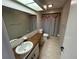 Bright bathroom features a vanity with a marble countertop and tiled floors at 1309 Malone Ave, Spring Hill, FL 34606