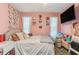 Bright bedroom with stylish decor, comfortable bed, and space-saving shelves at 1309 Malone Ave, Spring Hill, FL 34606