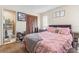 Comfortable bedroom featuring a pink bedspread, and an attached bathroom at 1309 Malone Ave, Spring Hill, FL 34606