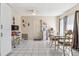 Bright dining area features white tile floors, neutral walls, and a charming dining set at 1309 Malone Ave, Spring Hill, FL 34606