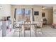 A dining room with white tile flooring and a table with four chairs at 1309 Malone Ave, Spring Hill, FL 34606