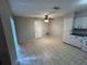 Dining room featuring tile floors, a ceiling fan with lighting, a door, and cabinets with drawers next to an appliance at 1309 Malone Ave, Spring Hill, FL 34606