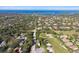 An aerial view of a neighborhood near a golf course with a bay in the distance at 1341 Marinella Dr, Palm Harbor, FL 34683