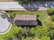 Aerial view showcasing the home's tiled roof, well-maintained lawn and landscaping, and neighborhood streets at 1341 Marinella Dr, Palm Harbor, FL 34683