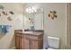 Bathroom with single vanity, fish decorations, and toilet at 1341 Marinella Dr, Palm Harbor, FL 34683