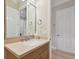 Bathroom with a light countertop, mirror, and light wood cabinets with white doors at 1341 Marinella Dr, Palm Harbor, FL 34683
