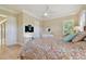 Well-lit bedroom features a ceiling fan, dedicated workspace, and ample natural light at 1341 Marinella Dr, Palm Harbor, FL 34683