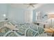 Bedroom with bright blue walls, ceiling fan, and white trim and furniture at 1341 Marinella Dr, Palm Harbor, FL 34684