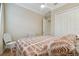 Cozy bedroom featuring a ceiling fan, patterned duvet, and white wicker furniture at 1341 Marinella Dr, Palm Harbor, FL 34683