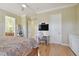 Comfortable bedroom featuring a workspace and view into the adjoining bathroom at 1341 Marinella Dr, Palm Harbor, FL 34683