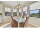 Bright dining room features a table with seating for six and black framed windows at 1341 Marinella Dr, Palm Harbor, FL 34683