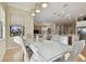 Open-concept dining room adjacent to the kitchen, island seating, and a living room at 1341 Marinella Dr, Palm Harbor, FL 34683
