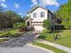 Charming two-story home with a brick driveway and vibrant landscaping at 1341 Marinella Dr, Palm Harbor, FL 34683