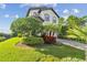Beautiful home featuring lush landscaping, a brick driveway, and a well-manicured lawn at 1341 Marinella Dr, Palm Harbor, FL 34683