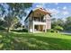 Beautiful two-story home features a large manicured lawn and a covered porch for outdoor enjoyment at 1341 Marinella Dr, Palm Harbor, FL 34683