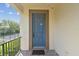 Front door of home with brick tiling, security camera, and dark hardware at 1341 Marinella Dr, Palm Harbor, FL 34683