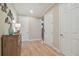 Well-lit hallway features hardwood floors, stylish furniture, and convenient access to multiple rooms at 1341 Marinella Dr, Palm Harbor, FL 34683