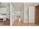 The hallway features hardwood floors, white trim, and access to an elevator and other rooms at 1341 Marinella Dr, Palm Harbor, FL 34684
