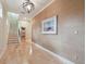 Bright hallway featuring wood floors and staircase leading to the upper level at 1341 Marinella Dr, Palm Harbor, FL 34683