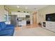 Open living area with stainless steel appliances and white cabinetry in the kitchen at 1341 Marinella Dr, Palm Harbor, FL 34683