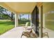 Covered patio with outdoor furniture overlooking a manicured lawn at 1341 Marinella Dr, Palm Harbor, FL 34683