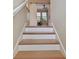 View of staircase leading to a room with a sliding barn door and a view of the interior at 1341 Marinella Dr, Palm Harbor, FL 34683