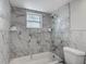 Bathroom with a tub and tiled walls at 1408 Maybury Dr, Holiday, FL 34691