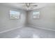Bedroom featuring tile floors and two windows at 1408 Maybury Dr, Holiday, FL 34691