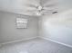 Bedroom featuring tile floors, a ceiling fan, and a window at 1408 Maybury Dr, Holiday, FL 34691