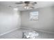 Bedroom featuring tile floors, a ceiling fan, and a window at 1408 Maybury Dr, Holiday, FL 34691