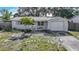Charming single-story home featuring a well-maintained lawn and attached one car garage at 1408 Maybury Dr, Holiday, FL 34691