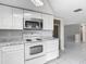 Kitchen featuring white appliances, granite countertops and tile floors at 1408 Maybury Dr, Holiday, FL 34691