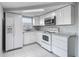 Kitchen featuring white appliances, granite countertops and tile floors at 1408 Maybury Dr, Holiday, FL 34691