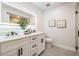 Sleek bathroom with double vanity, modern fixtures, well lit mirror, and stylish tile flooring at 14903 Winterwind Dr, Tampa, FL 33624