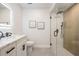 Bright bathroom features a sleek vanity with modern fixtures and a glass-enclosed shower with rainfall shower head at 14903 Winterwind Dr, Tampa, FL 33624
