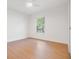 This bright, empty bedroom features wood-look flooring, a ceiling fan, and natural light from a window at 14903 Winterwind Dr, Tampa, FL 33624