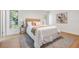 Bright bedroom with neutral tones, large windows, and wood-look flooring, creating a serene atmosphere at 14903 Winterwind Dr, Tampa, FL 33624