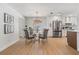 Dining area with table and seating next to kitchen, stainless refrigerator and stylish modern lighting at 14903 Winterwind Dr, Tampa, FL 33624