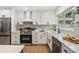 Bright kitchen showcasing white cabinetry, stainless steel appliances, and modern countertops at 14903 Winterwind Dr, Tampa, FL 33624
