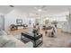 Expansive open-concept living space showcasing wood floors, modern decor, and seamless flow to the kitchen at 14903 Winterwind Dr, Tampa, FL 33624