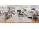 Cozy living room with fireplace, ceiling fan, neutral furniture, and sliding doors to the outdoor area at 14903 Winterwind Dr, Tampa, FL 33624