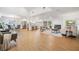 Bright open-concept living area featuring wood floors, a fireplace, and a seamless flow to the kitchen and dining area at 14903 Winterwind Dr, Tampa, FL 33624