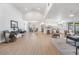 Spacious open-concept living area with wood floors, modern furnishings, and seamless flow to the kitchen at 14903 Winterwind Dr, Tampa, FL 33624