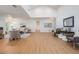 Large open-concept living area with hardwood floors, modern decor, and easy access to other rooms in the home at 14903 Winterwind Dr, Tampa, FL 33624