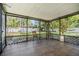 Screened lanai with tile flooring offers views of the fenced backyard at 14903 Winterwind Dr, Tampa, FL 33624
